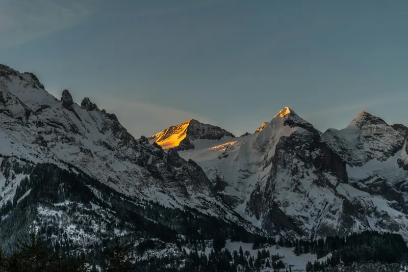 Snow-covered mountain range at sunset